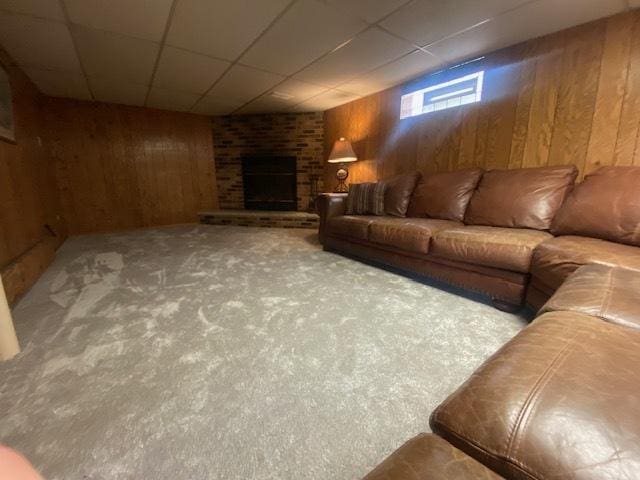10900 S Tripp Ave, Oak Lawn, IL 60453 - living area with wood walls, carpet flooring, a brick fireplace, and a paneled ceiling