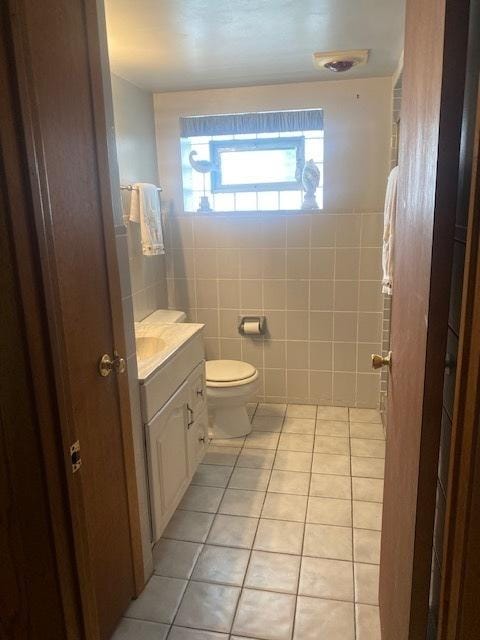 10900 S Tripp Ave, Oak Lawn, IL 60453 - bathroom featuring tile patterned flooring, vanity, and tile walls