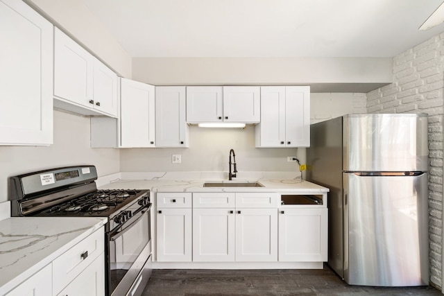 3075 Kingston Ct, Streamwood, IL 60107 - kitchen with stainless steel appliances, white cabinetry, light stone countertops, and brick wall