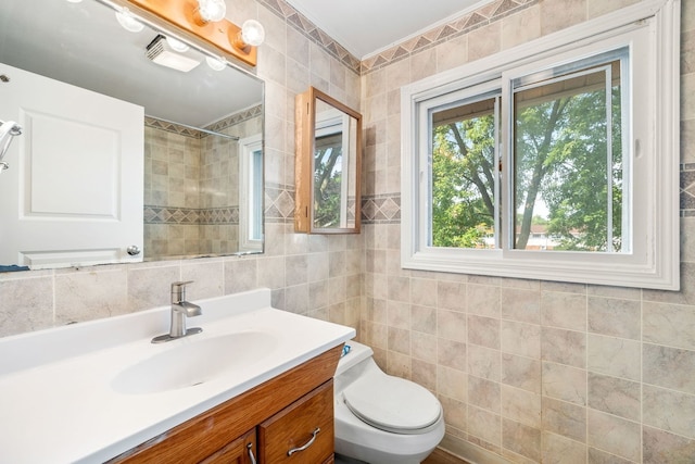 3075 Kingston Ct, Streamwood, IL 60107 - bathroom featuring tile walls, vanity, and a tile shower