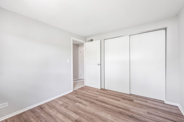 3075 Kingston Ct, Streamwood, IL 60107 - unfurnished bedroom with wood finished floors and a closet