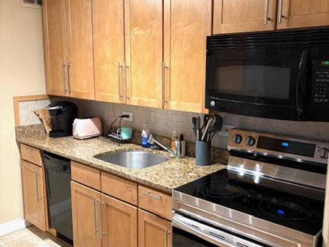 1339 N Dearborn St Unit 4A, Chicago, IL 60610 - kitchen featuring black appliances, tasteful backsplash, and light stone counters