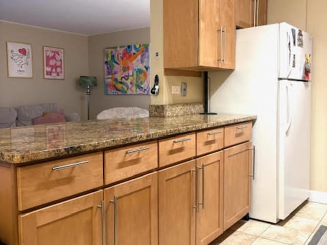 1339 N Dearborn St Unit 4A, Chicago, IL 60610 - kitchen featuring freestanding refrigerator, dark stone counters, a peninsula, and open floor plan