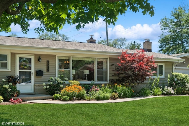 3245 Greenbriar Dr, Glenview, IL 60025 - view of front of house with a chimney, a front yard, and roof with shingles