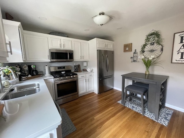 1110 Pike St, Peru, IL 61354 - kitchen with stainless steel appliances, dark wood-style flooring, and white cabinetry