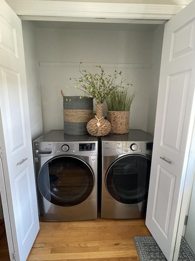 1110 Pike St, Peru, IL 61354 - washroom with light wood-style floors and independent washer and dryer