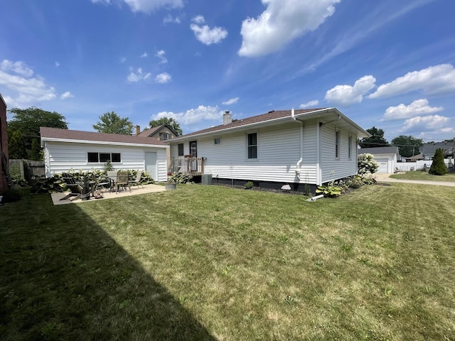 1110 Pike St, Peru, IL 61354 - back of house featuring a lawn, a patio, a chimney, and a detached garage