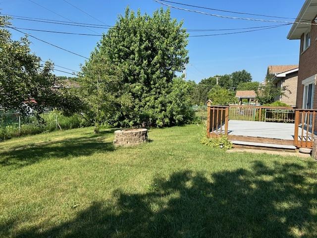 9842 S 88th Ave, Palos Hills, IL 60465 - view of green lawn with a wooden deck