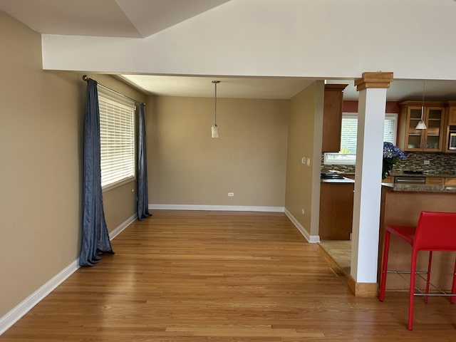 9842 S 88th Ave, Palos Hills, IL 60465 - unfurnished dining area with light wood-style floors and baseboards