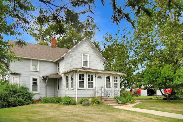 2840 W Ziebarth Rd, Normal, IL 61761 - view of front of property with a chimney, a front lawn, and a shingled roof