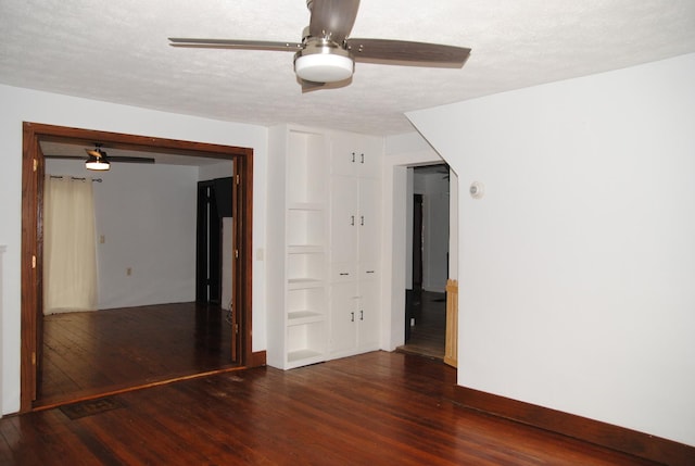 2840 W Ziebarth Rd, Normal, IL 61761 - spare room featuring a ceiling fan, wood finished floors, a textured ceiling, and built in shelves