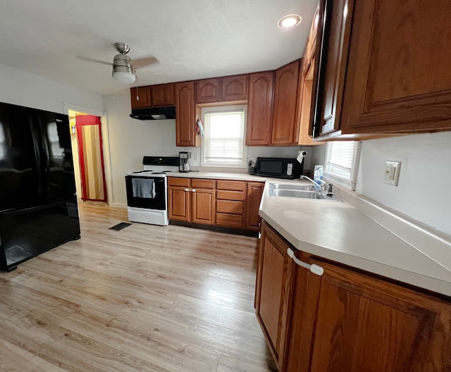 2840 W Ziebarth Rd, Normal, IL 61761 - kitchen featuring black appliances, under cabinet range hood, a ceiling fan, light wood finished floors, and light countertops