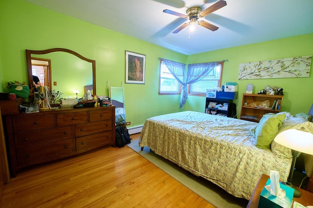 4444 N Central Ave Unit 2W, Chicago, IL 60630 - bedroom with a baseboard heating unit, light wood-type flooring, and ceiling fan