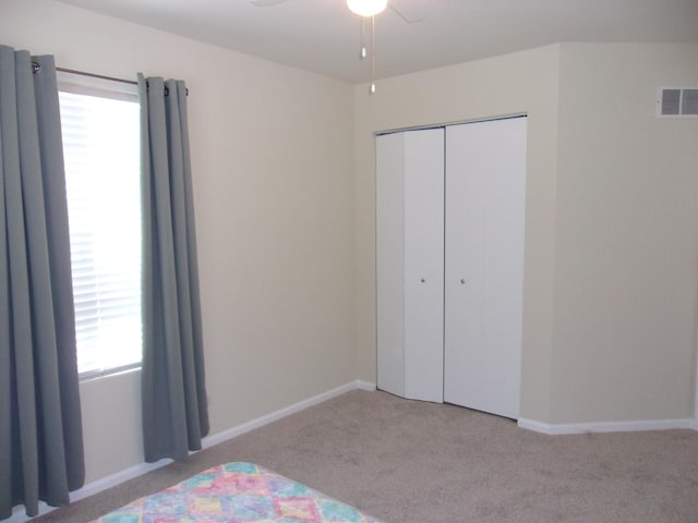 570 Windsor Dr Unit 570, Fox Lake, IL 60020 - unfurnished bedroom featuring carpet flooring, multiple windows, and a closet