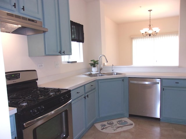 570 Windsor Dr Unit 570, Fox Lake, IL 60020 - kitchen with stainless steel appliances, under cabinet range hood, blue cabinets, and plenty of natural light