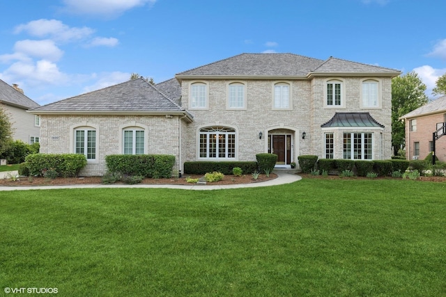 1600 Elderberry Dr, Libertyville, IL 60048 - french country style house featuring a front lawn and brick siding