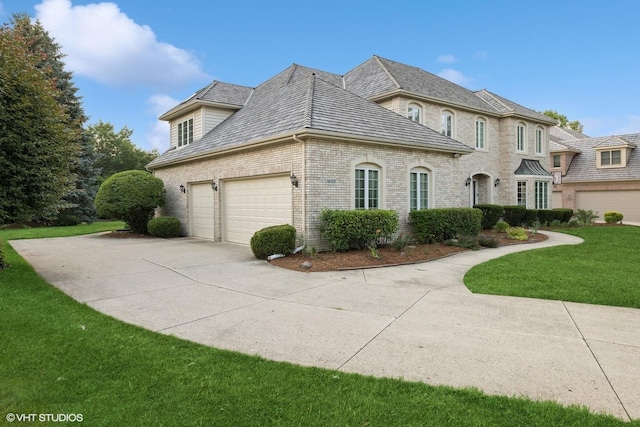 1600 Elderberry Dr, Libertyville, IL 60048 - view of home's exterior with brick siding, driveway, a lawn, and a high end roof