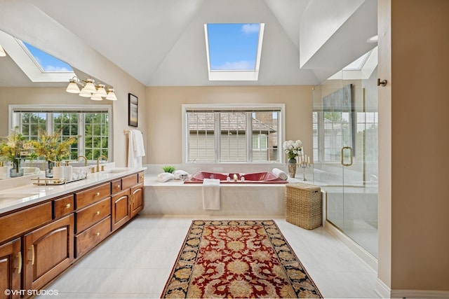 1600 Elderberry Dr, Libertyville, IL 60048 - bathroom featuring a skylight, double vanity, a garden tub, vaulted ceiling, and a stall shower