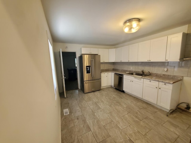 2053 219th Pl, Sauk Village, IL 60411 - kitchen with stainless steel appliances, white cabinets, and light stone counters