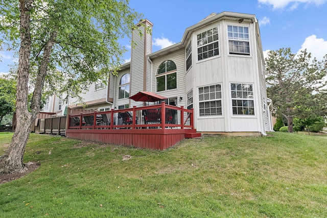 229 Ascot Ln, Streamwood, IL 60107 - back of house with a chimney, a wooden deck, and a yard