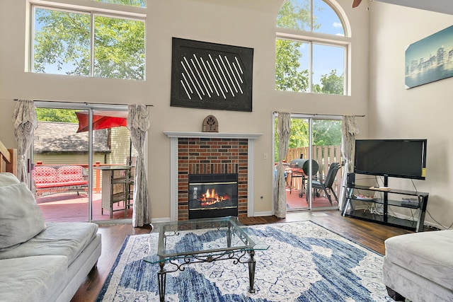 229 Ascot Ln, Streamwood, IL 60107 - living room featuring a towering ceiling, plenty of natural light, a fireplace, and wood finished floors