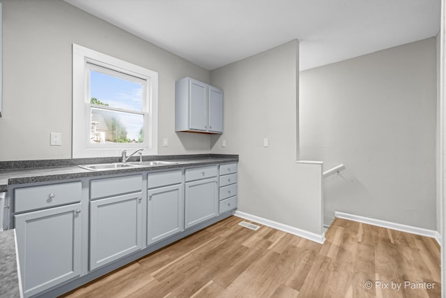 2213 Elm St, Rockford, IL 61102 - kitchen with dark countertops and light wood finished floors