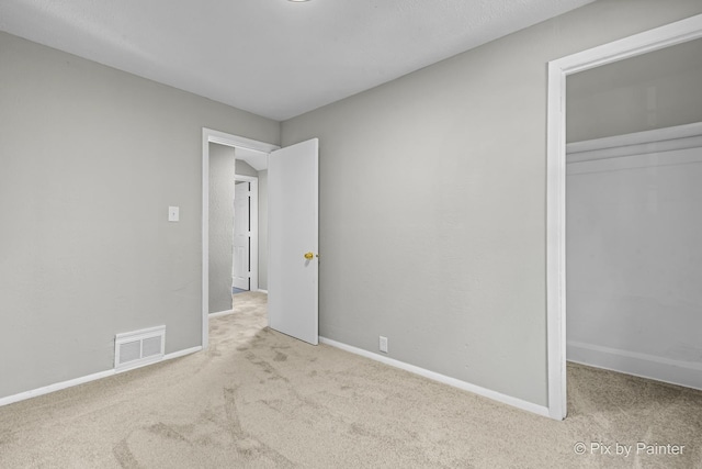 2213 Elm St, Rockford, IL 61102 - unfurnished bedroom featuring carpet, a closet, and a spacious closet