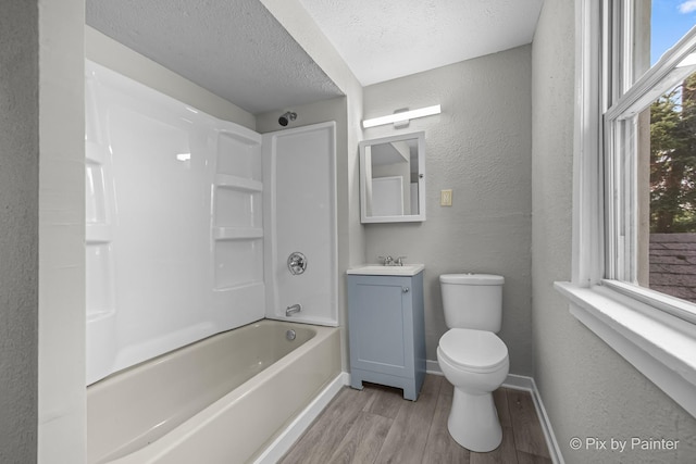 2213 Elm St, Rockford, IL 61102 - full bath with wood finished floors, a textured wall, vanity, a textured ceiling, and bathing tub / shower combination