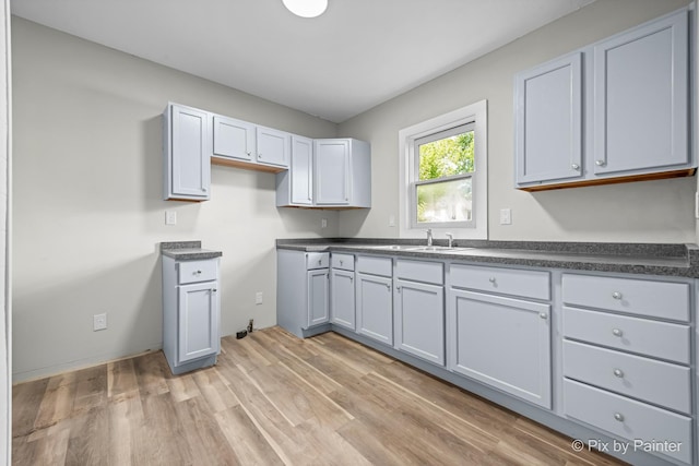 2213 Elm St, Rockford, IL 61102 - kitchen with dark countertops and light wood-style flooring