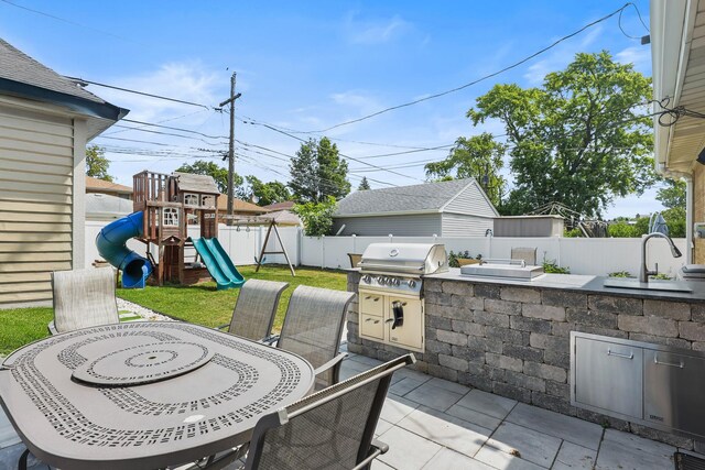 4944 Jarvis Ave, Skokie, IL 60077 - fenced backyard with an outdoor kitchen, outdoor dining space, a patio, and a playground
