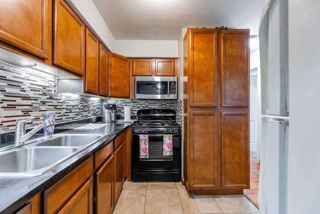 5715 Park Pl Unit K1, Crestwood, IL 60418 - kitchen featuring stainless steel microwave, black gas range oven, backsplash, dark countertops, and brown cabinetry