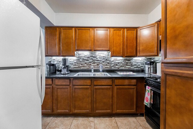 5715 Park Pl Unit K1, Crestwood, IL 60418 - kitchen featuring freestanding refrigerator, dark countertops, black gas range, and tasteful backsplash