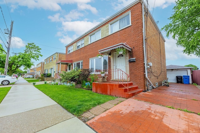 5228 W 54th St, Chicago, IL 60638 - view of front facade featuring brick siding, a front yard, a detached garage, and an outbuilding