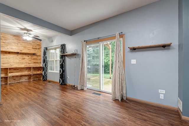 2517 Oak Tree Ln, Plainfield, IL 60586 - spare room featuring wood finished floors, ceiling fan, beamed ceiling, and wooden walls