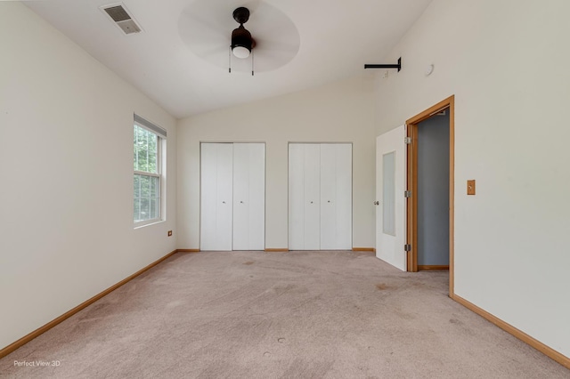 2517 Oak Tree Ln, Plainfield, IL 60586 - unfurnished bedroom with multiple closets, vaulted ceiling, carpet floors, and a ceiling fan