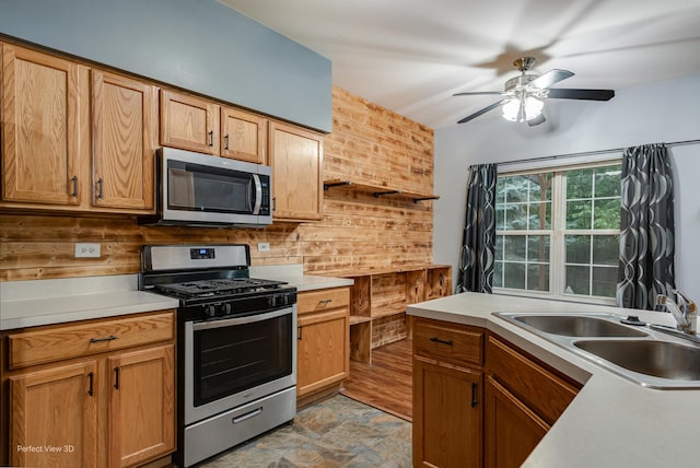 2517 Oak Tree Ln, Plainfield, IL 60586 - kitchen with stainless steel appliances, a ceiling fan, and light countertops
