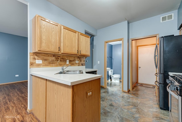 2517 Oak Tree Ln, Plainfield, IL 60586 - kitchen with stainless steel stove, backsplash, light brown cabinetry, light countertops, and a peninsula