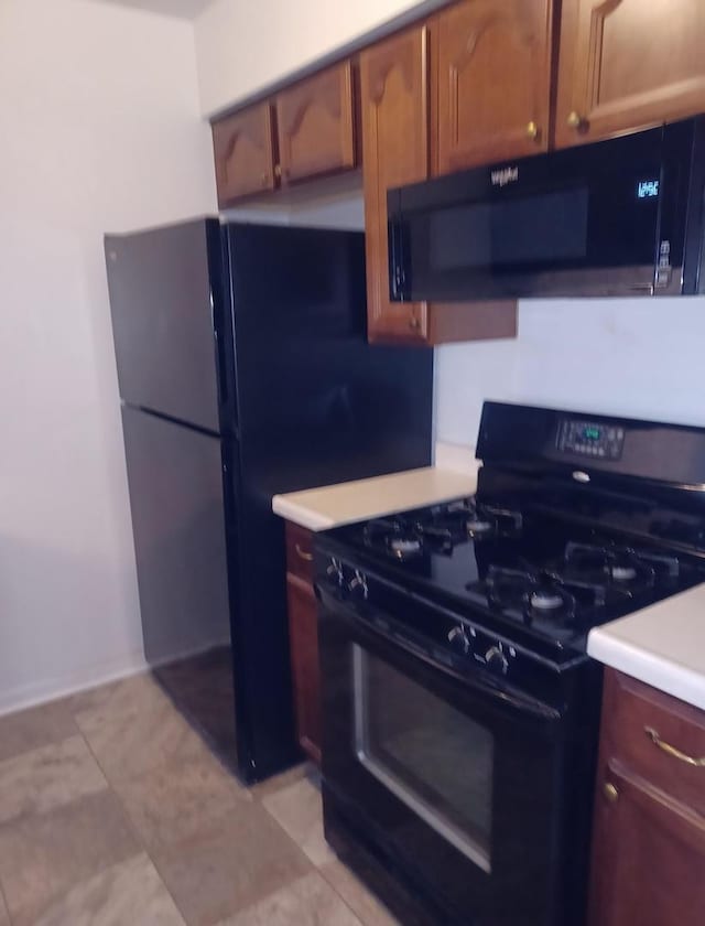 20137 Woodale St Unit 20137, Lynwood, IL 60411 - kitchen with black appliances, light countertops, light tile patterned floors, and brown cabinets