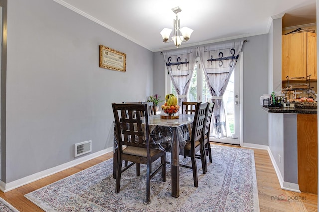 23W073 Dickens Ave, Glen Ellyn, IL 60137 - dining space featuring a chandelier, ornamental molding, and light wood finished floors