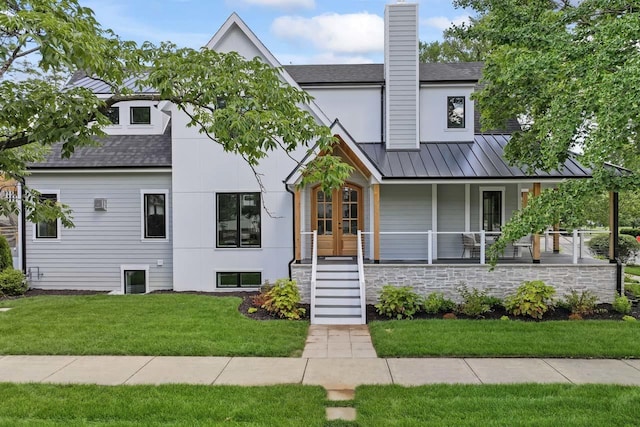1100 Washington St, Glenview, IL 60025 - modern farmhouse style home featuring a standing seam roof, a shingled roof, a front lawn, a metal roof, and a chimney