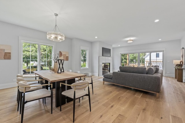 1100 Washington St, Glenview, IL 60025 - dining area with light wood-type flooring, recessed lighting, a chandelier, and a tiled fireplace