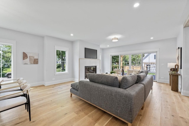 1100 Washington St, Glenview, IL 60025 - living area featuring healthy amount of natural light, light wood-type flooring, recessed lighting, and a glass covered fireplace