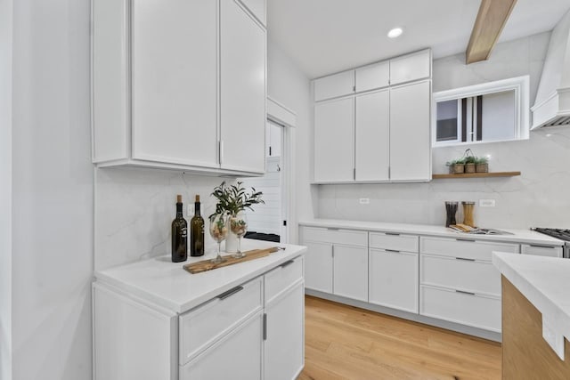 1100 Washington St, Glenview, IL 60025 - kitchen featuring open shelves, custom exhaust hood, decorative backsplash, white cabinetry, and light countertops