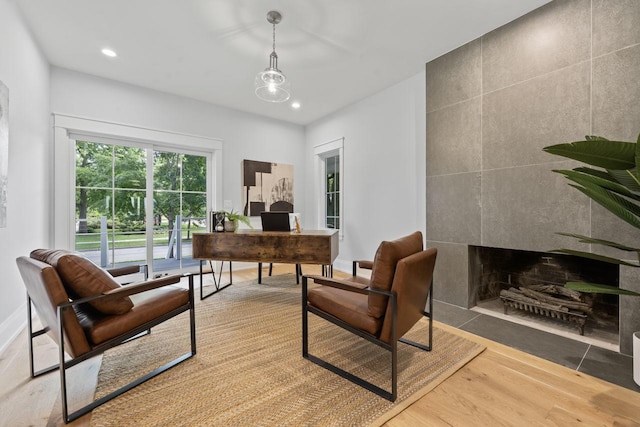 1100 Washington St, Glenview, IL 60025 - office area with wood finished floors, a tiled fireplace, and recessed lighting