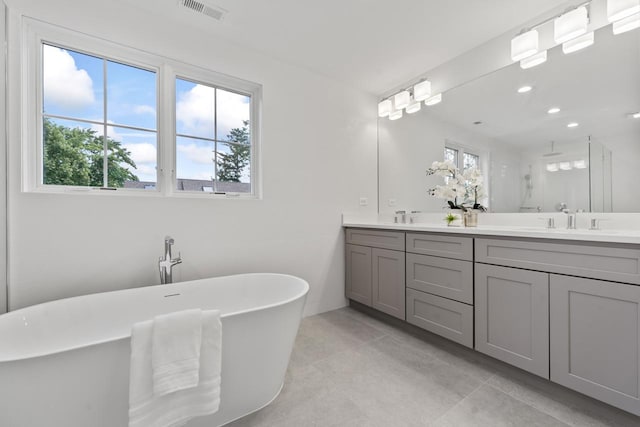 1100 Washington St, Glenview, IL 60025 - full bath with double vanity, a freestanding tub, walk in shower, tile patterned flooring, and recessed lighting