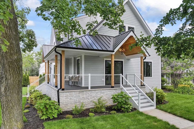 1100 Washington St, Glenview, IL 60025 - view of front of house featuring a standing seam roof, a porch, a metal roof, and a front lawn