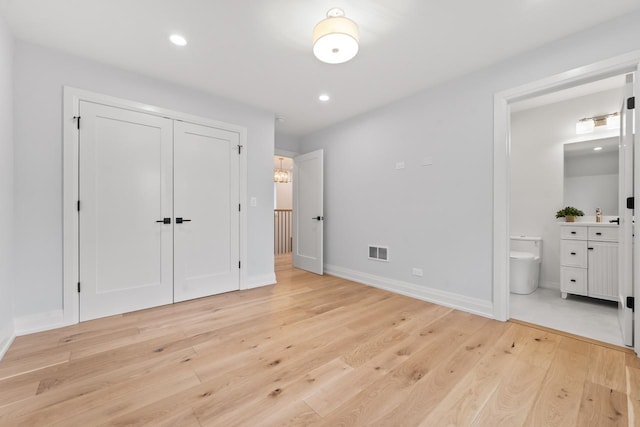 1100 Washington St, Glenview, IL 60025 - unfurnished bedroom featuring light wood-style floors, connected bathroom, a closet, and recessed lighting