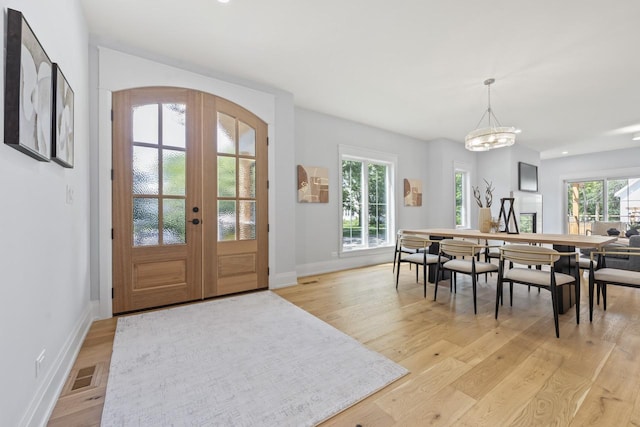 1100 Washington St, Glenview, IL 60025 - entryway featuring light wood-style floors, french doors, and a chandelier