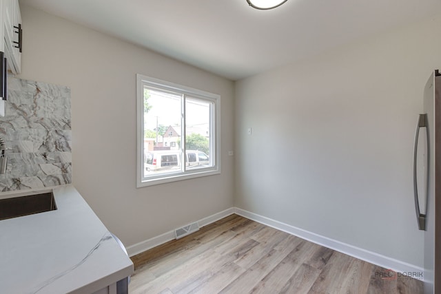 4603 Main St Unit B, Skokie, IL 60076 - unfurnished dining area featuring light wood-style flooring and baseboards