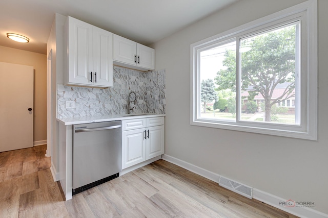4603 Main St Unit B, Skokie, IL 60076 - kitchen with dishwasher, light countertops, decorative backsplash, light wood-type flooring, and white cabinetry